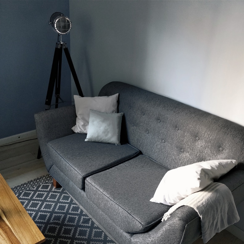 light blue wall gray sofa