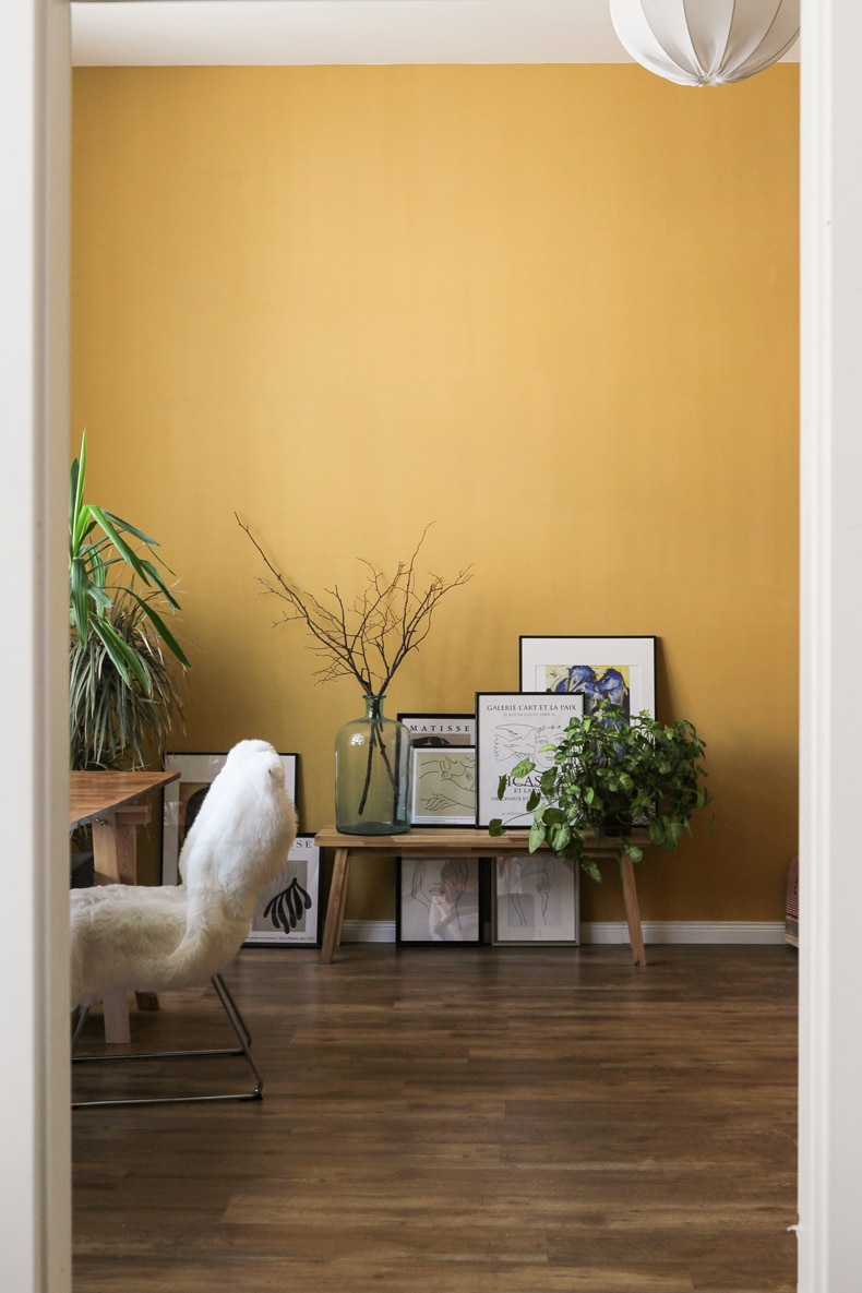 room with mustard wall and beige furnitures