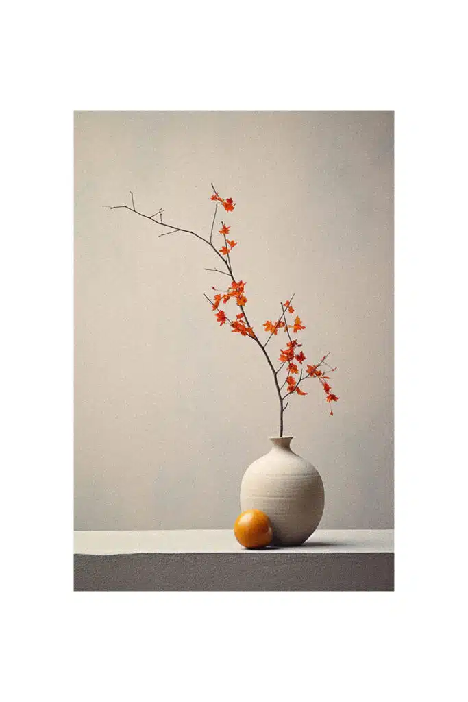 Autumn decorating idea: A white vase with a vibrant orange in it.