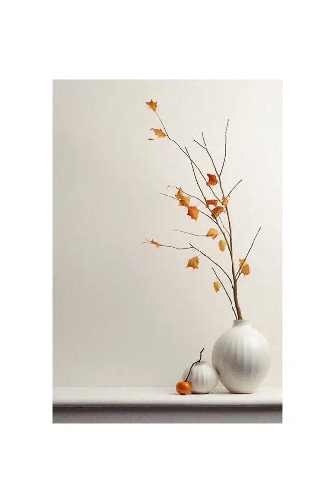 Autumn decorating idea: orange leaves on a white vase.