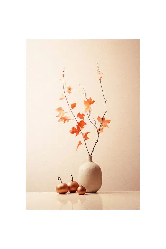 Autumn decorating ideas featuring a white vase filled with orange leaves.