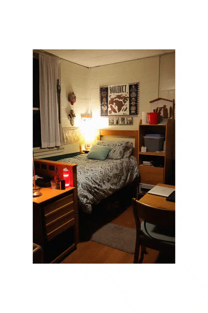 A cozy college dorm room with a bed and a desk.