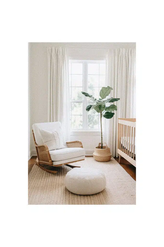 Nursery room with a rocking chair and plant, providing inspiration for baby's room.