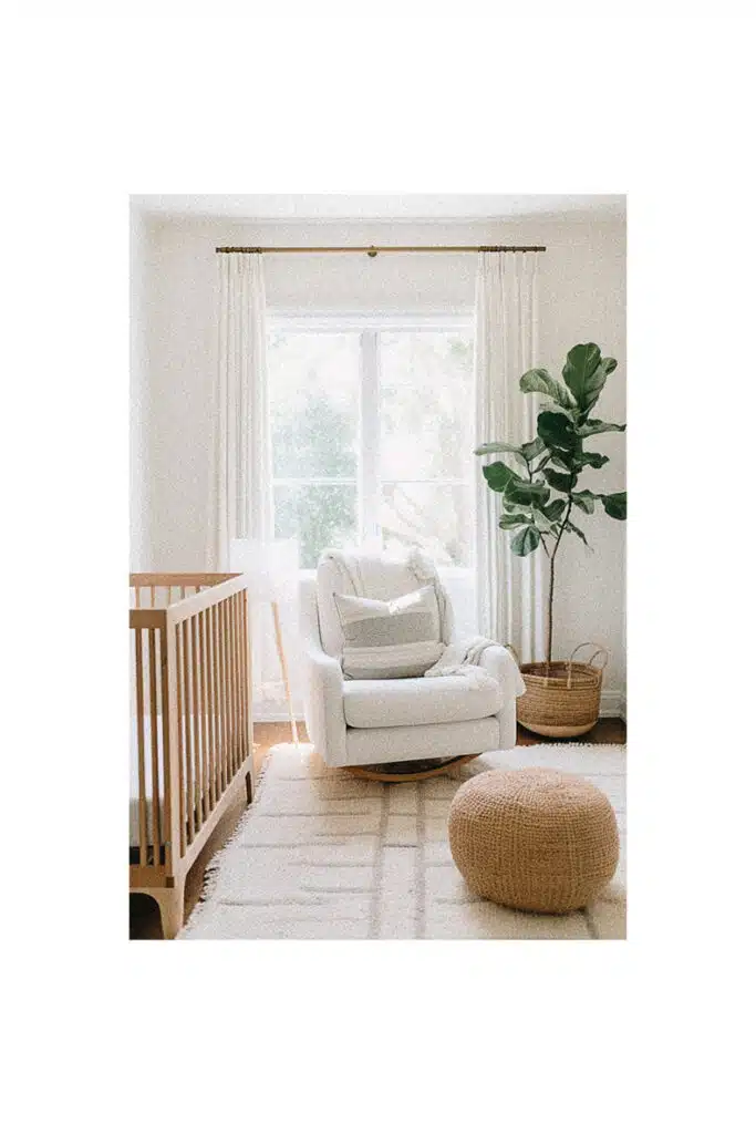 Nursery room inspiration with a white crib and a plant.