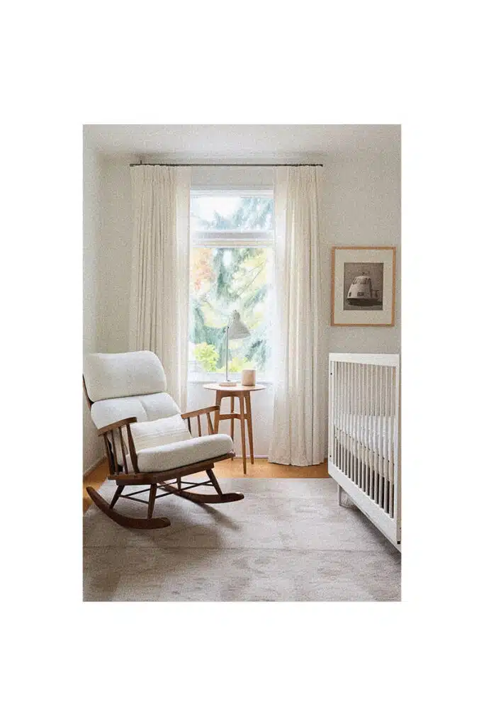 Nursery room with a rocking chair and a window, providing inspiration.