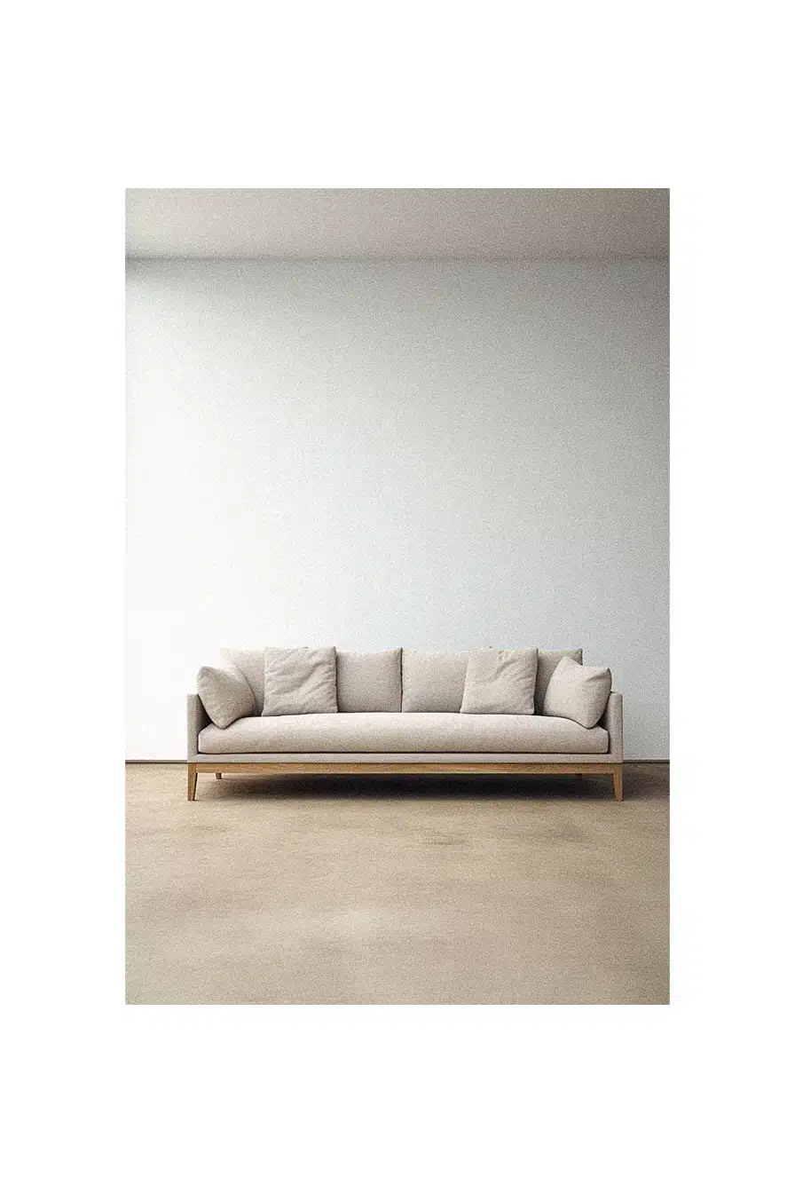 A simple white couch in an empty room.