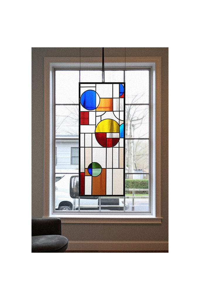A beautiful stained glass window art piece adorns the living room.