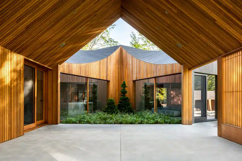 A modern house with wooden walls and a glass door.