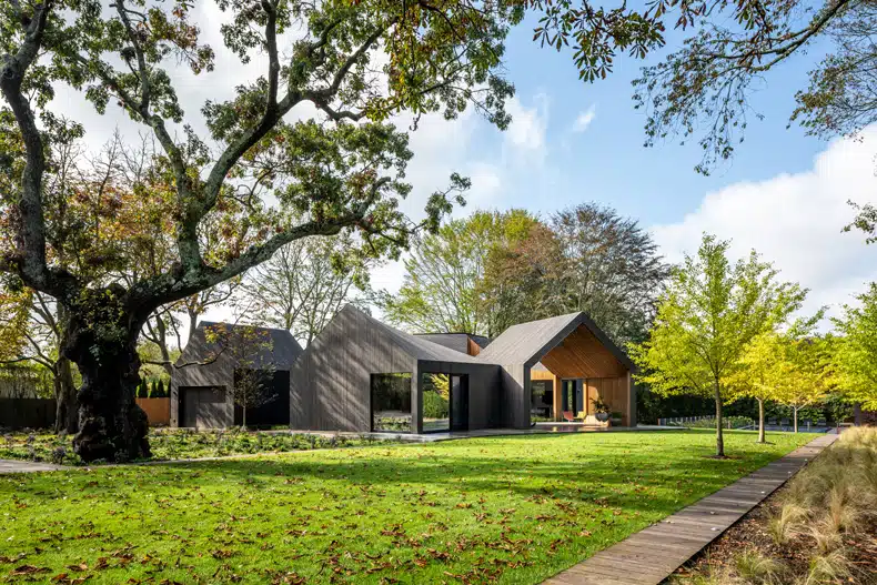 The house is surrounded by trees and grass.