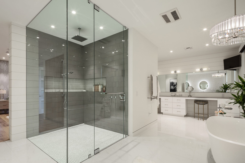 A modern bathroom with a glass shower stall.