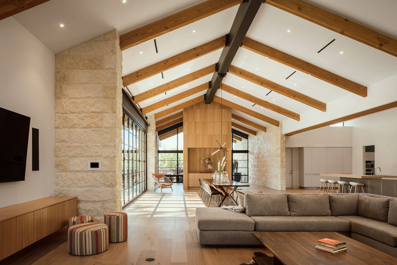 A modern living room with wooden beams.