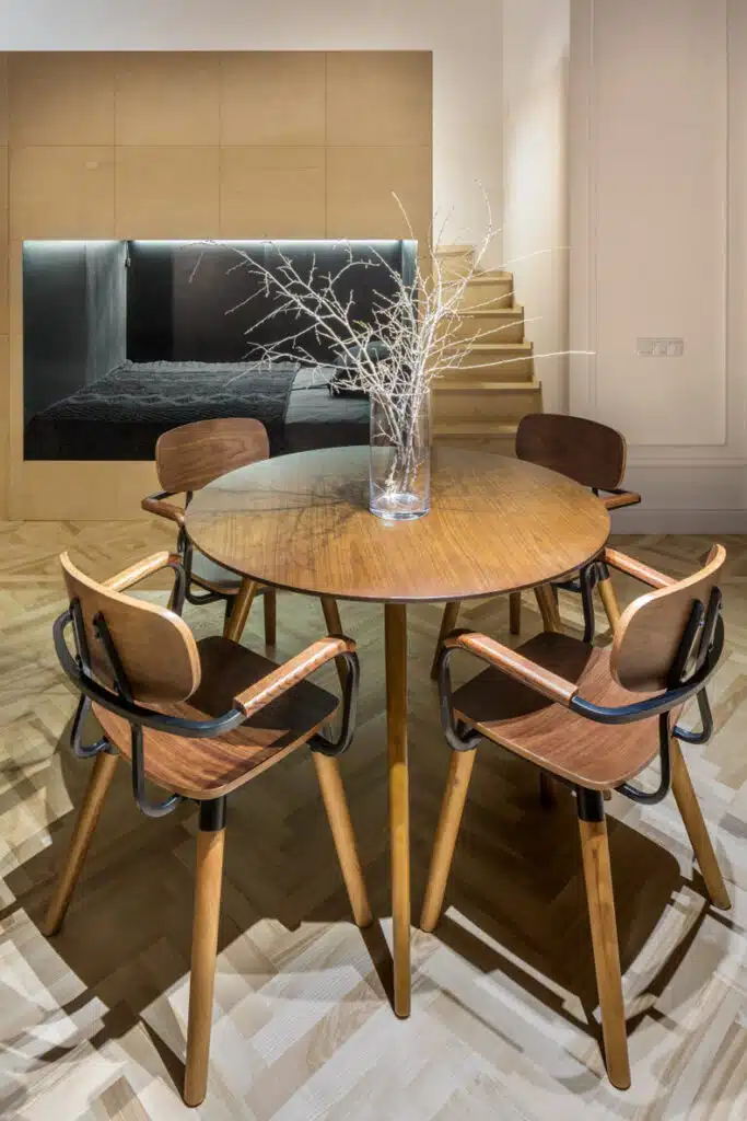 A Smart 60 Apartment with a dining room featuring a wooden table and chairs.