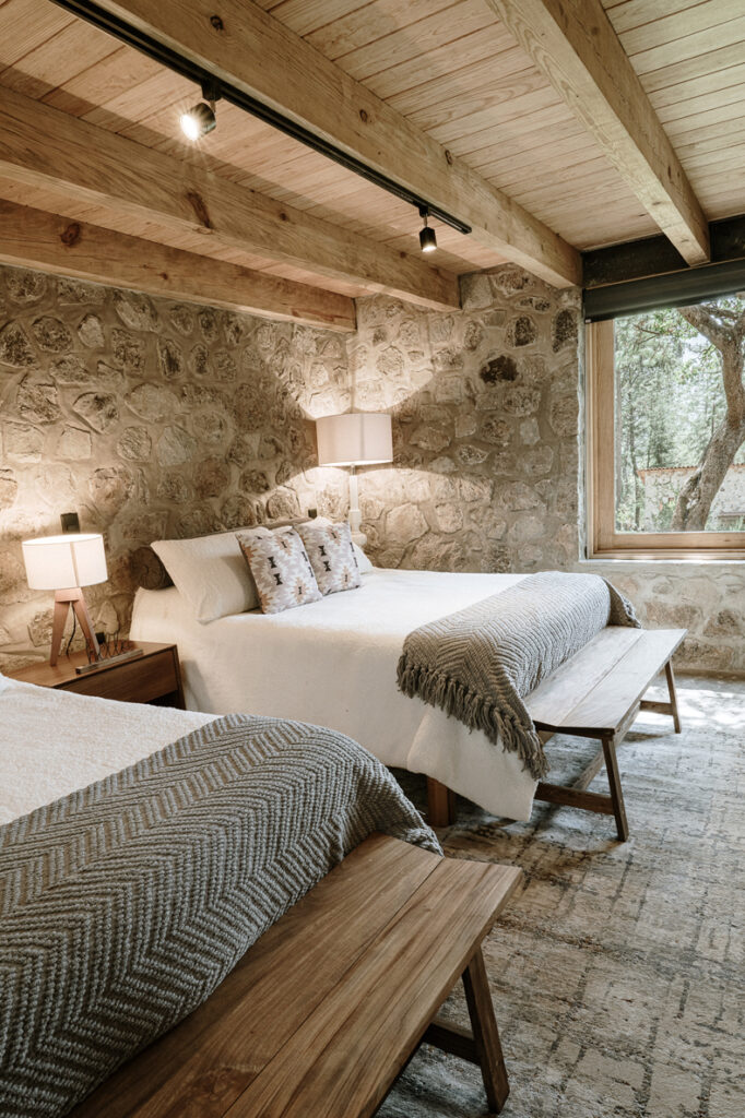 Petraia House By Argdl offers a rustic setting with stone-walled rooms featuring two beds.