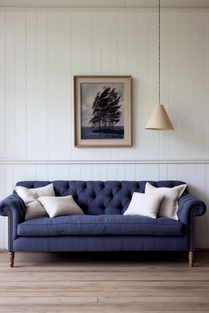 A blue sofa in a room with a painting on the wall, featuring go together three colors.