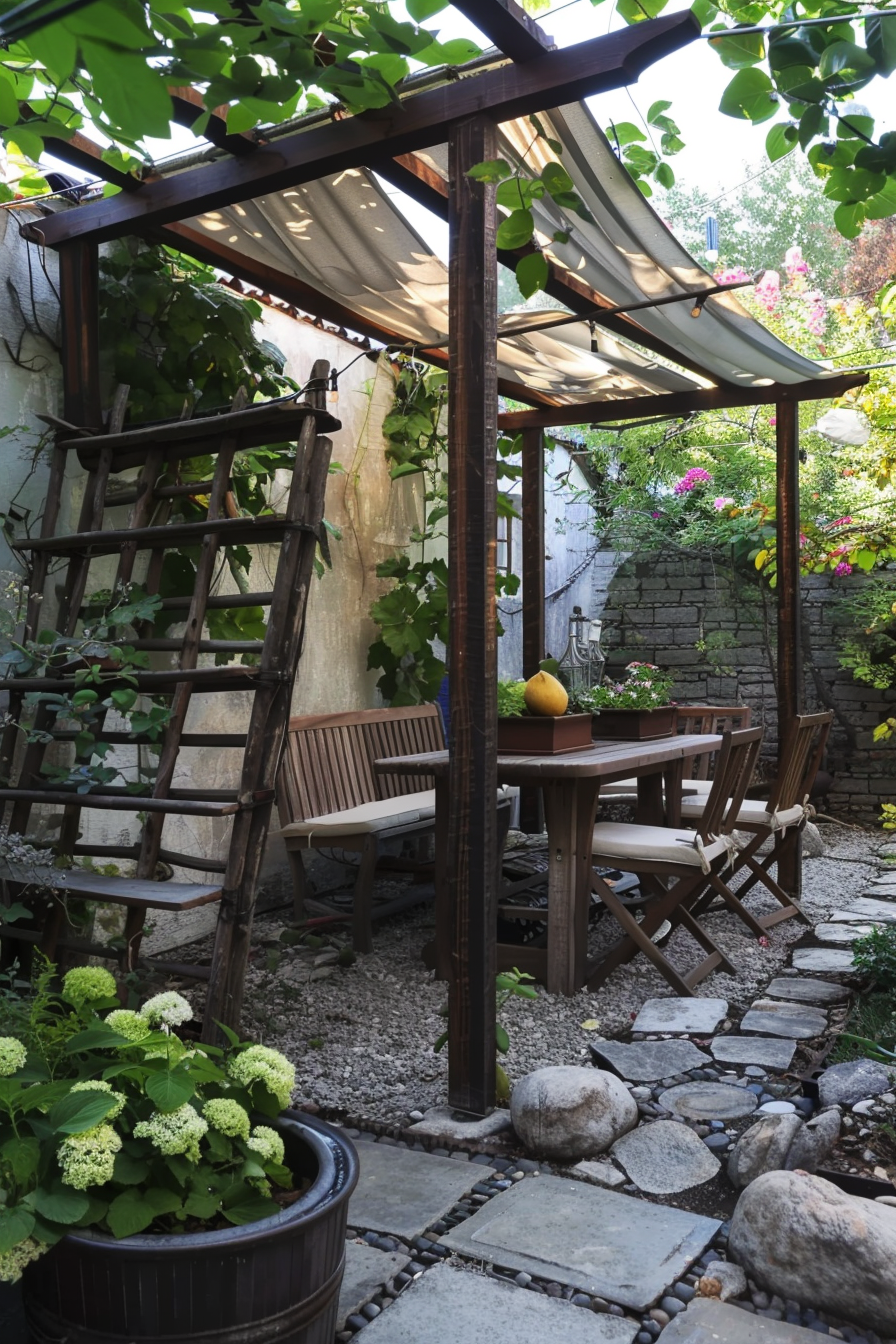 Cozy garden patio with wooden table and chairs, a pergola overhead, surrounded by greenery and flowers.