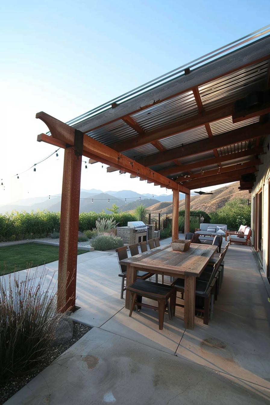 An outdoor patio with a wooden dining set, string lights, and a view of distant mountains at dusk.