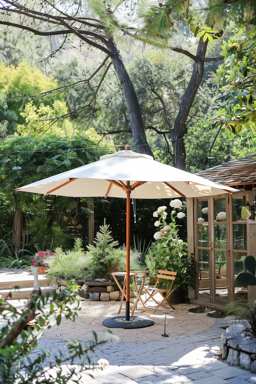 Outdoor patio with umbrella, chairs, and greenery surrounding a cozy garden nook.