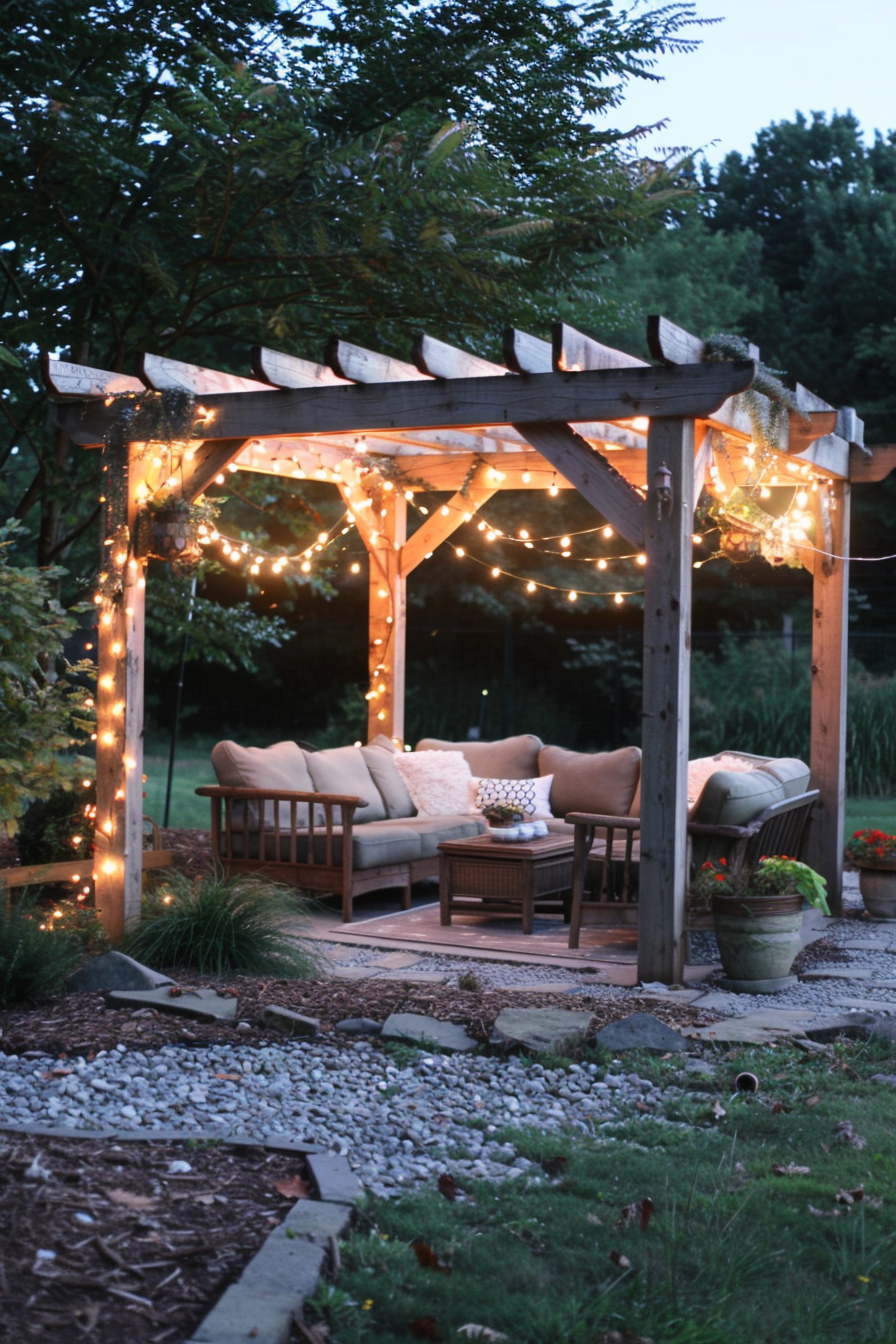 A cozy garden pergola with string lights, wooden sofa set, in a twilight setting.