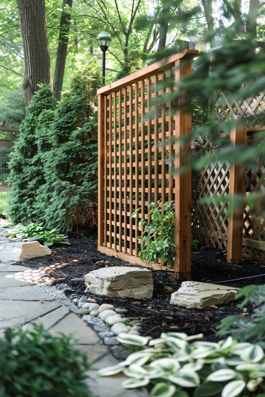 A wooden lattice garden fence surrounded by lush greenery, with a pathway leading through a landscaped yard.