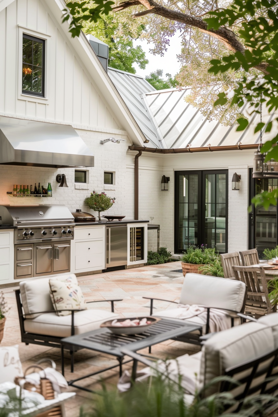 ALT Text: "Elegant outdoor kitchen with stainless steel appliances and white cabinetry, adjacent to a cozy seating area with comfortable chairs."