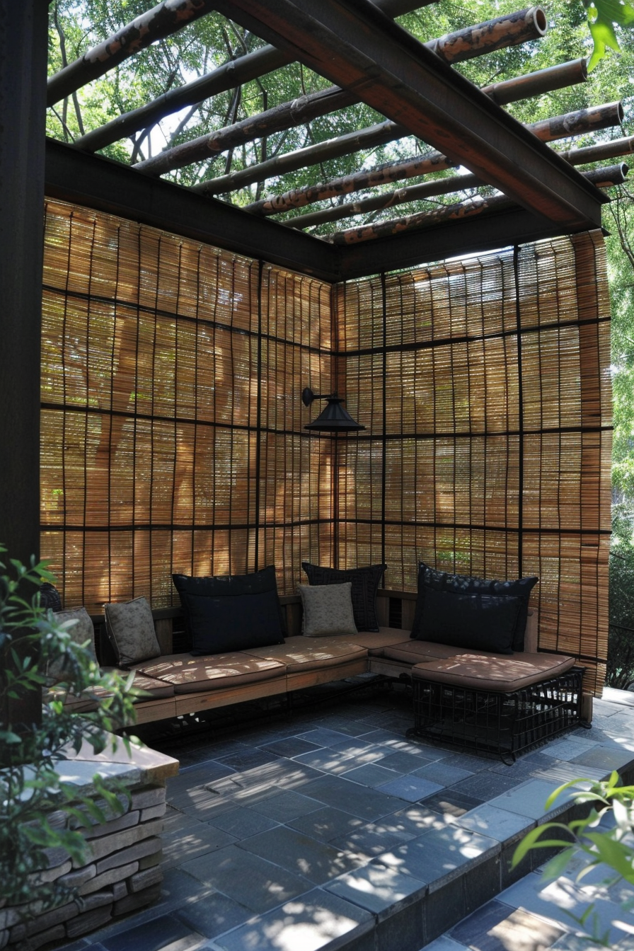 Outdoor patio area with wooden benches, cushions, and bamboo privacy screens under a pergola with snow-covered logs.