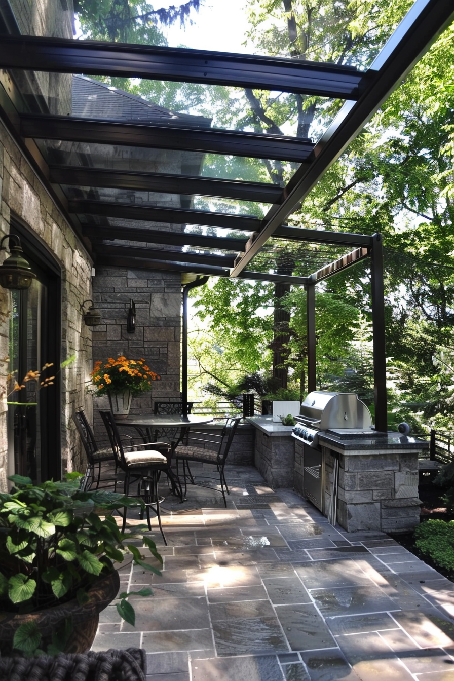 Outdoor patio area with glass roof, stone walls, a built-in grill, dining furniture, and surrounding greenery.