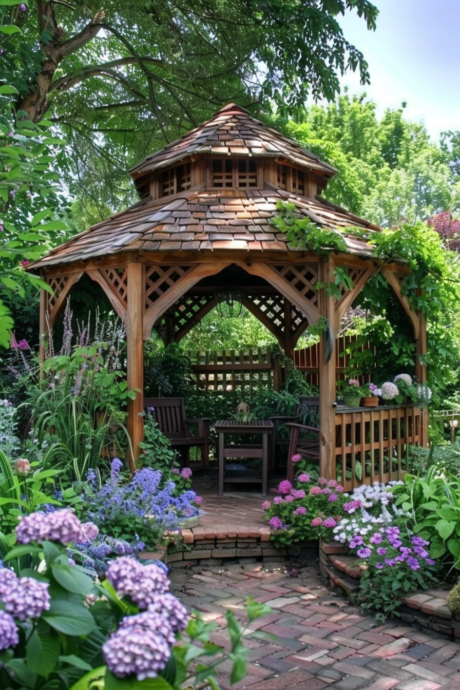 Wooden garden gazebo surrounded by lush flowers and greenery with a seating area inside.
