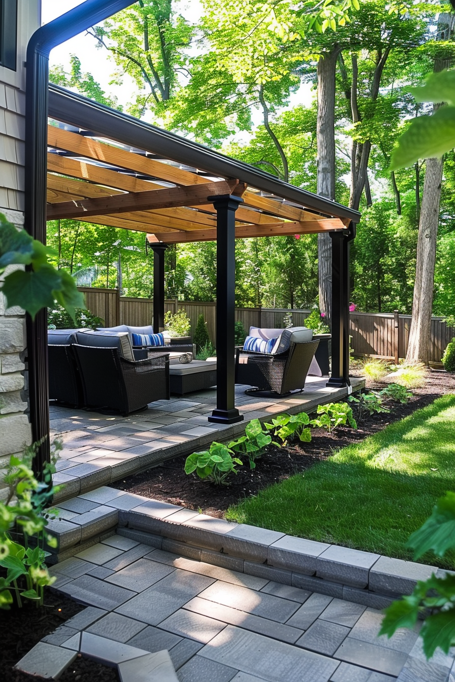 A cozy outdoor patio area with furniture under a wooden pergola, surrounded by green plants and trees.