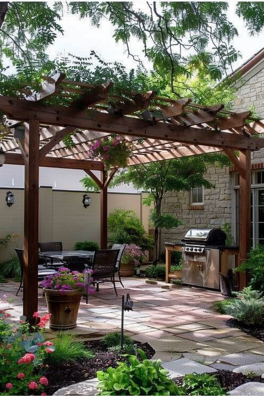 A cozy backyard patio with pergola, furniture, a grill, and vibrant plants under a sunny sky.