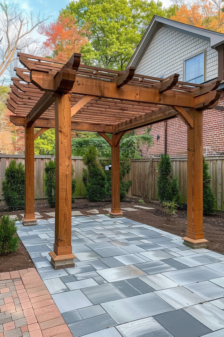 ALT: A wooden pergola with intricate lattice design over a patterned tile patio in a fenced backyard, with lush greenery and a house in the background.