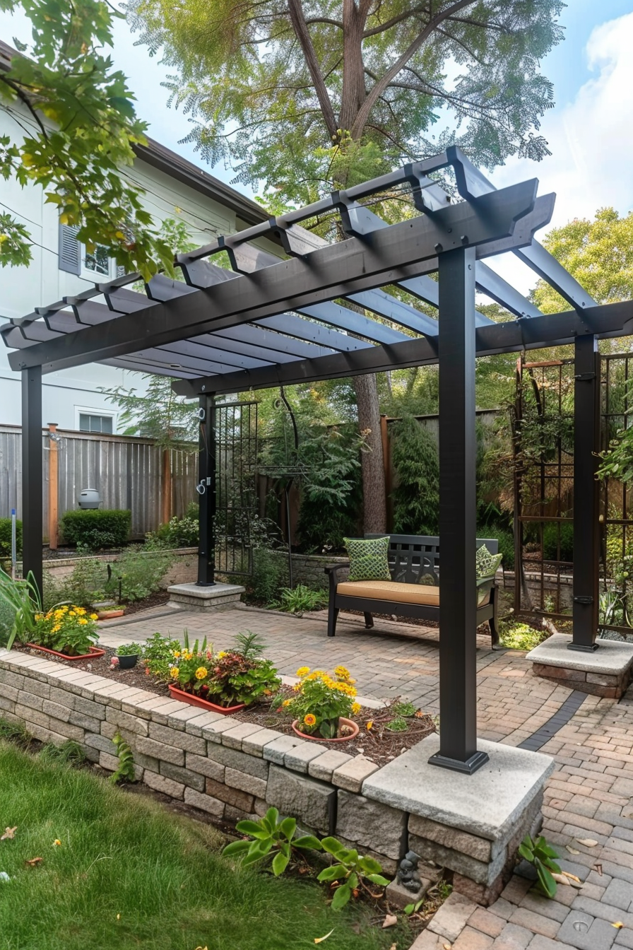 ALT: A cozy backyard patio with a bench under a modern pergola, surrounded by greenery, flowering plants, and a brick pathway.