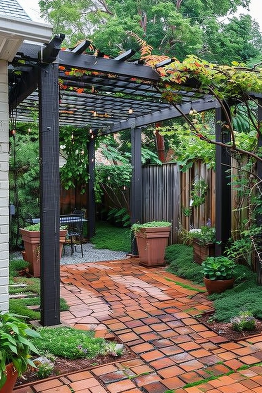 ALT: A serene brick patio with a black pergola overhead, adorned with climbing plants, flanked by greenery and outdoor seating.