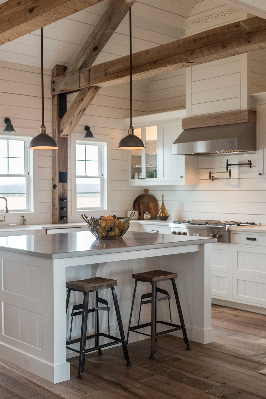A cozy modern kitchen with white cabinetry, wooden beams, pendant lights, and bar stools at an island with a bowl of fruit.