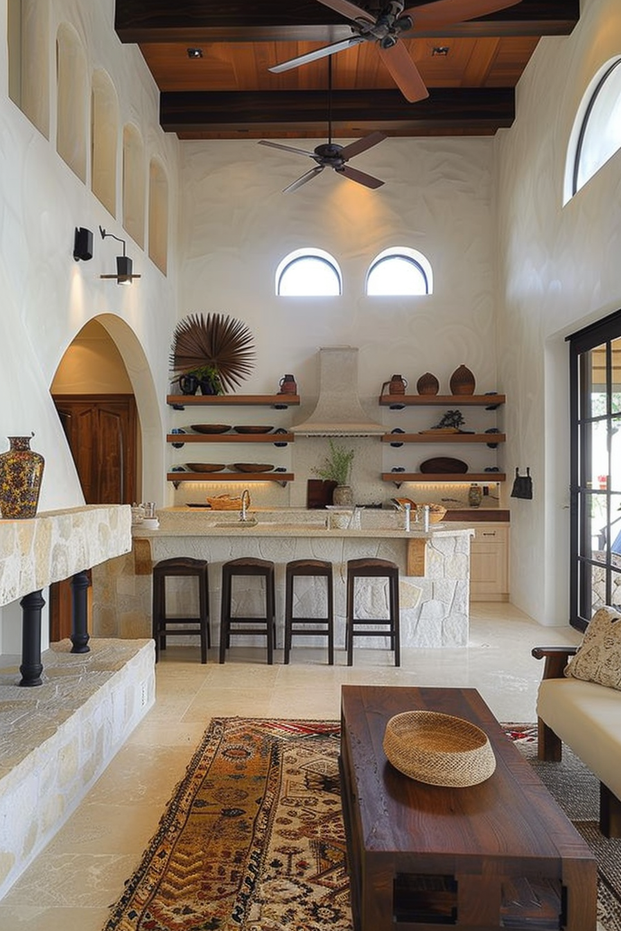 Elegant kitchen interior with arched alcoves, wooden ceiling beams, a stone countertop with bar stools, and decorative pottery on shelves.