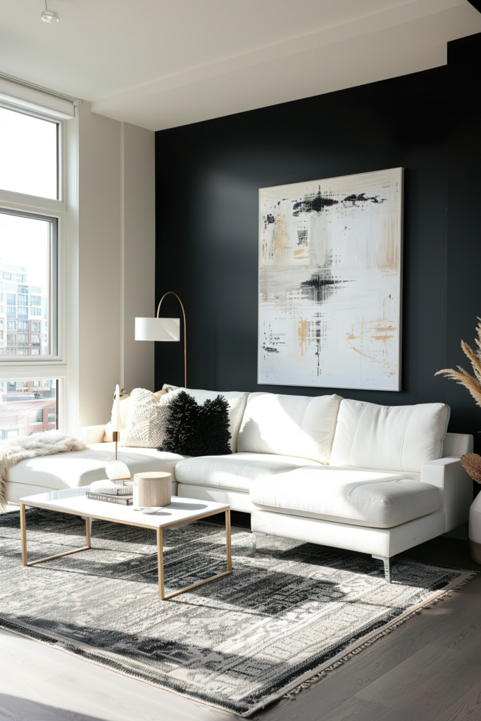 Modern living room with white sofa, abstract wall art, black accent wall, and sunlight streaming through a window.