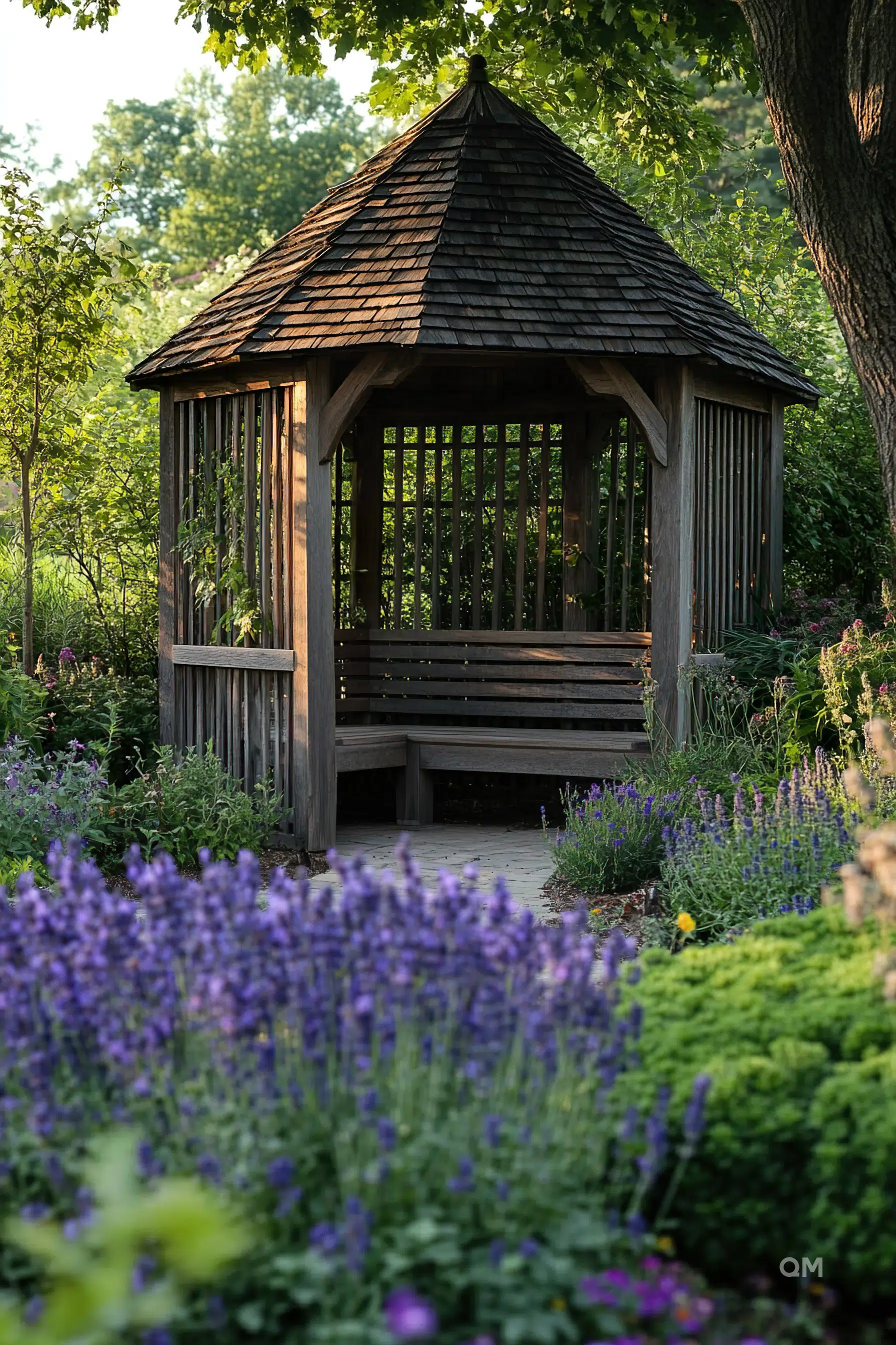 Wooden gazebo amid a lush garden with blooming purple flowers and greenery in a serene park setting.