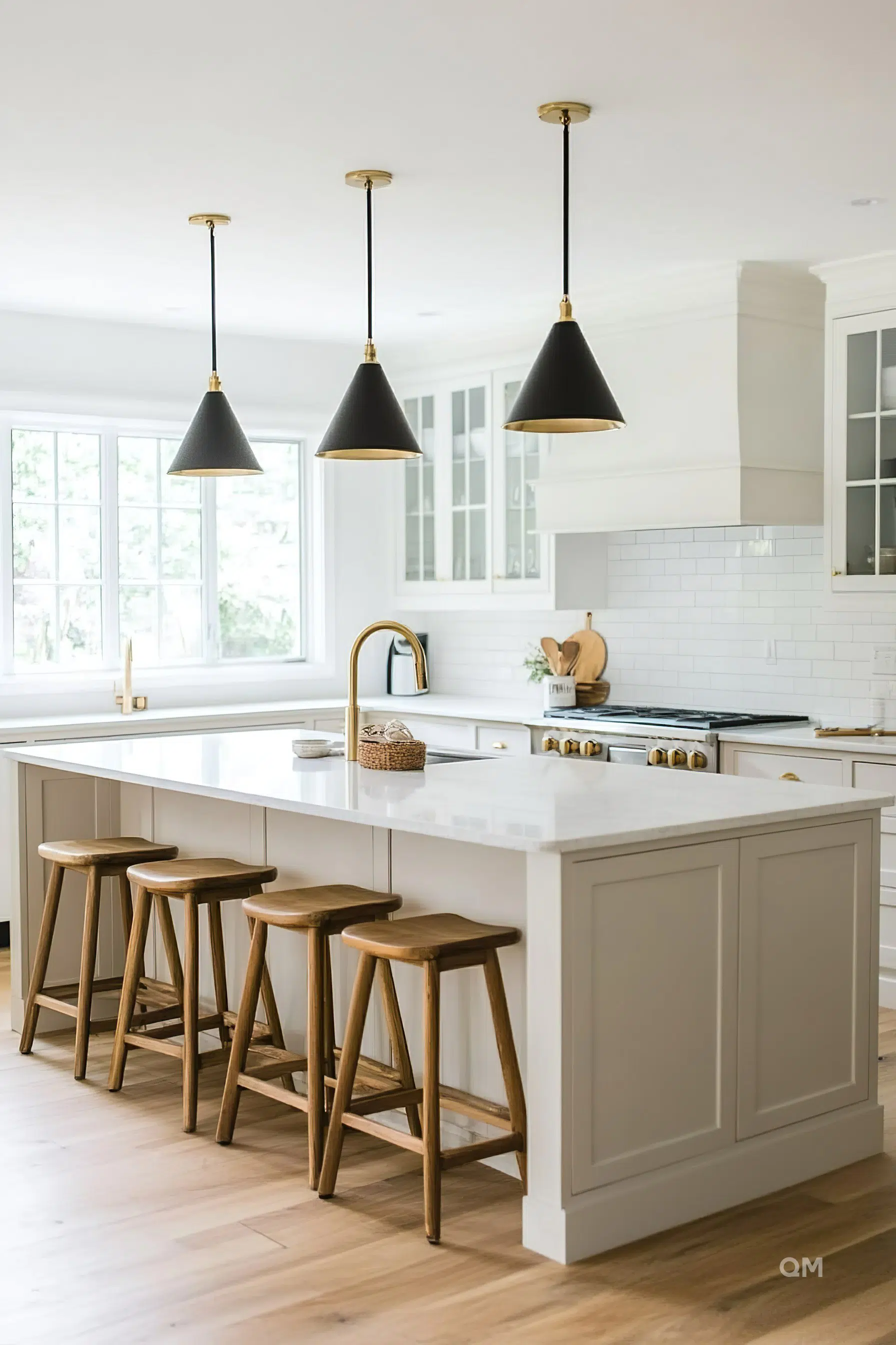 Modern kitchen interior with white countertops, wooden stools, and black pendant lights. Modern kitchen interior with white countertops, wooden stools, and black pendant lights.