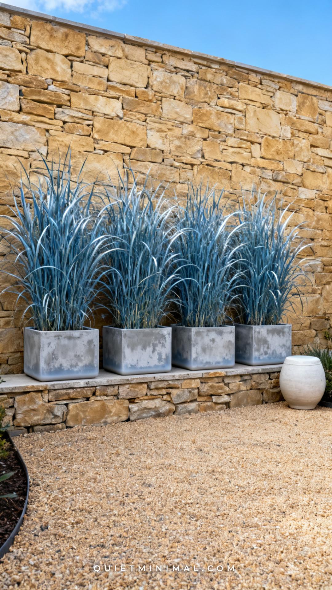 A vertical photograph captures a wide establishing shot of a backyard gravel garden area where a row of four medium rect