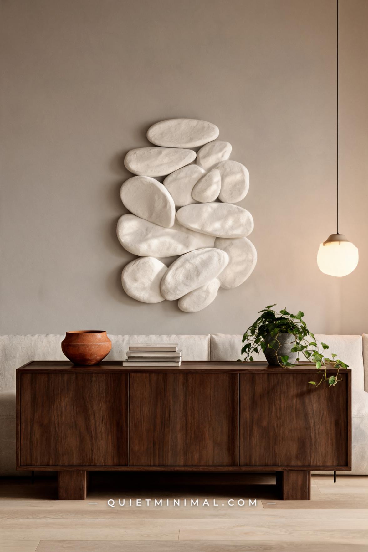 A vertical photograph captures a styled living room showing a large horizontal black-and-white landscape photograph — a