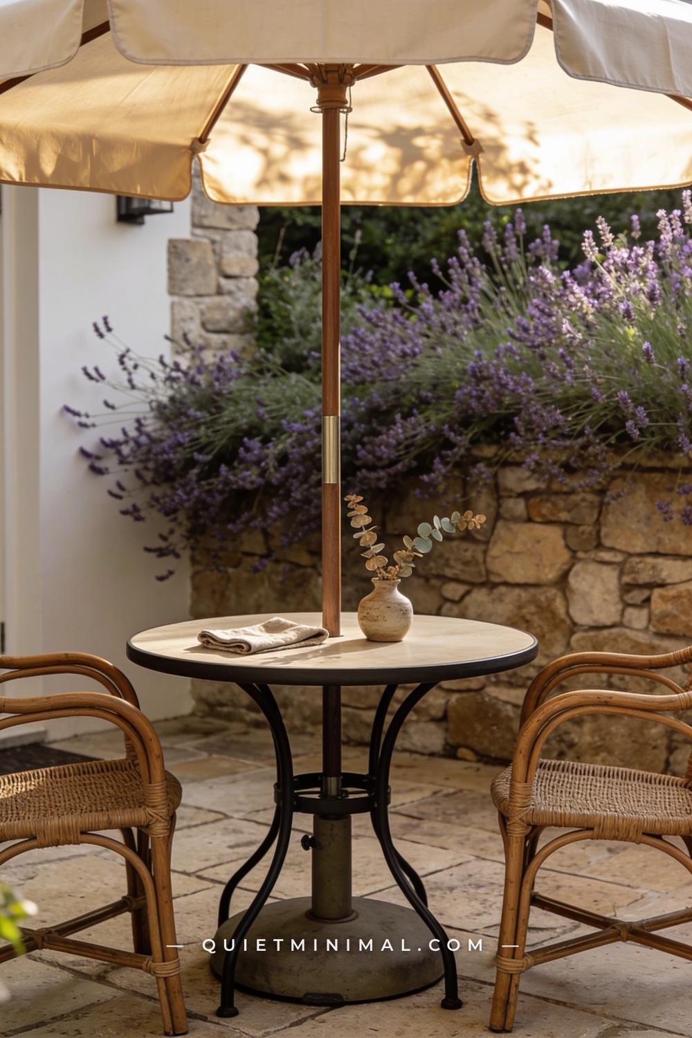 A vertical photograph captures a round bistro table on a stone patio