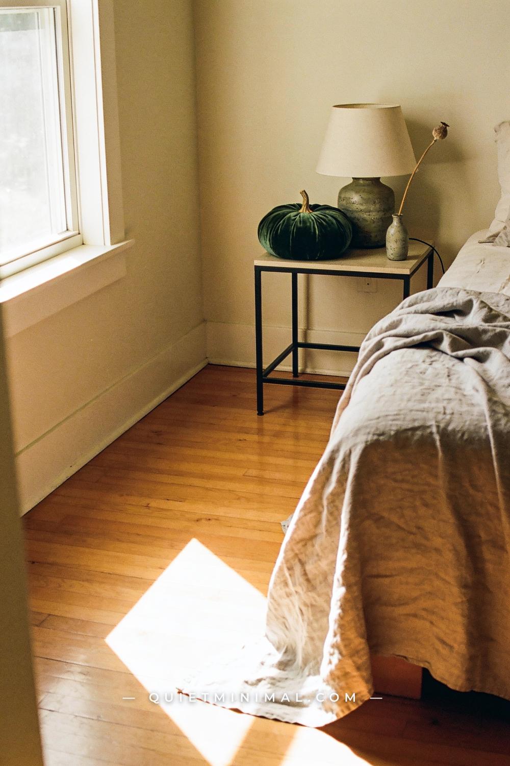 A wide establishing shot from the far corner of a bedroom