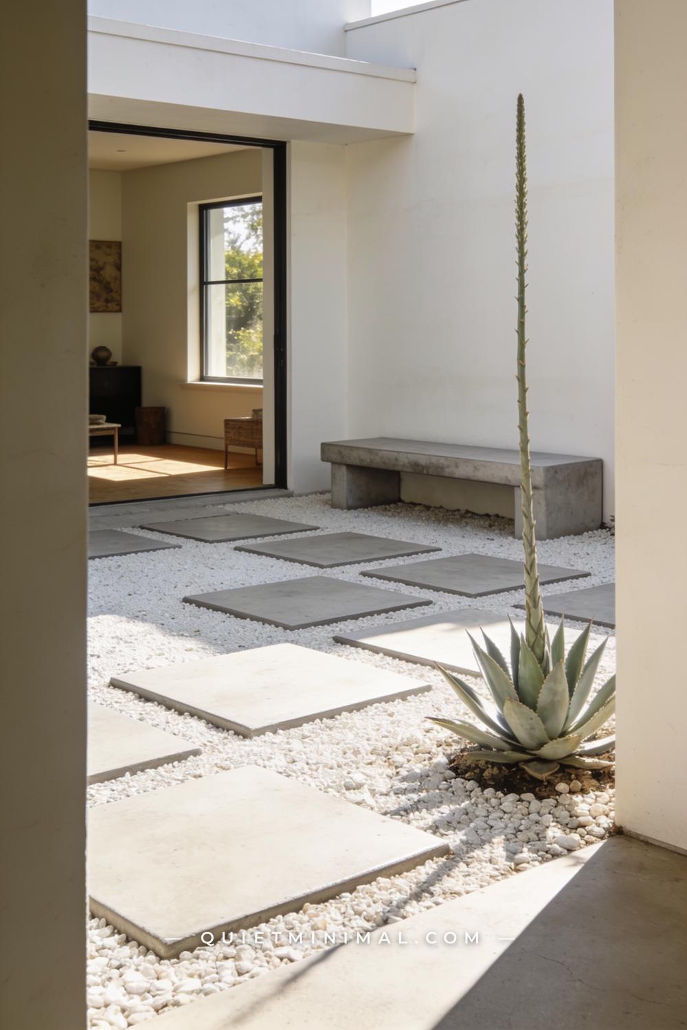 A wide vertical photograph of a minimalist backyard where oversized 24-inch square concrete pavers are placed in a loose