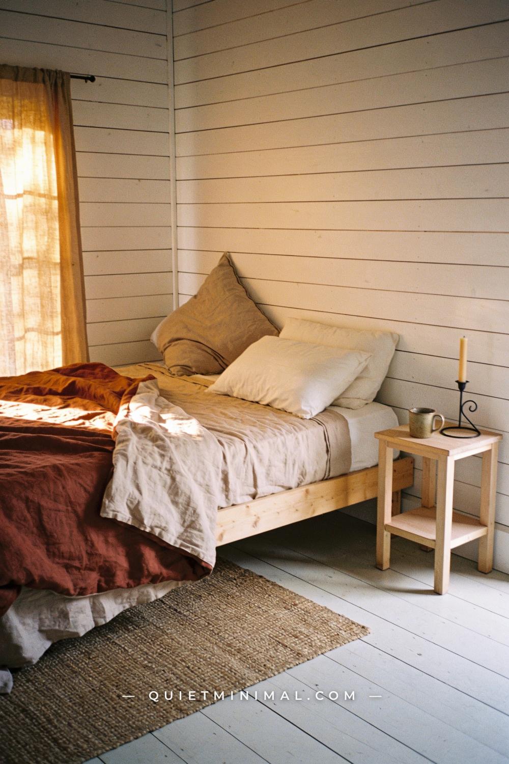 A wide establishing shot from the foot of the bed across the full bedroom