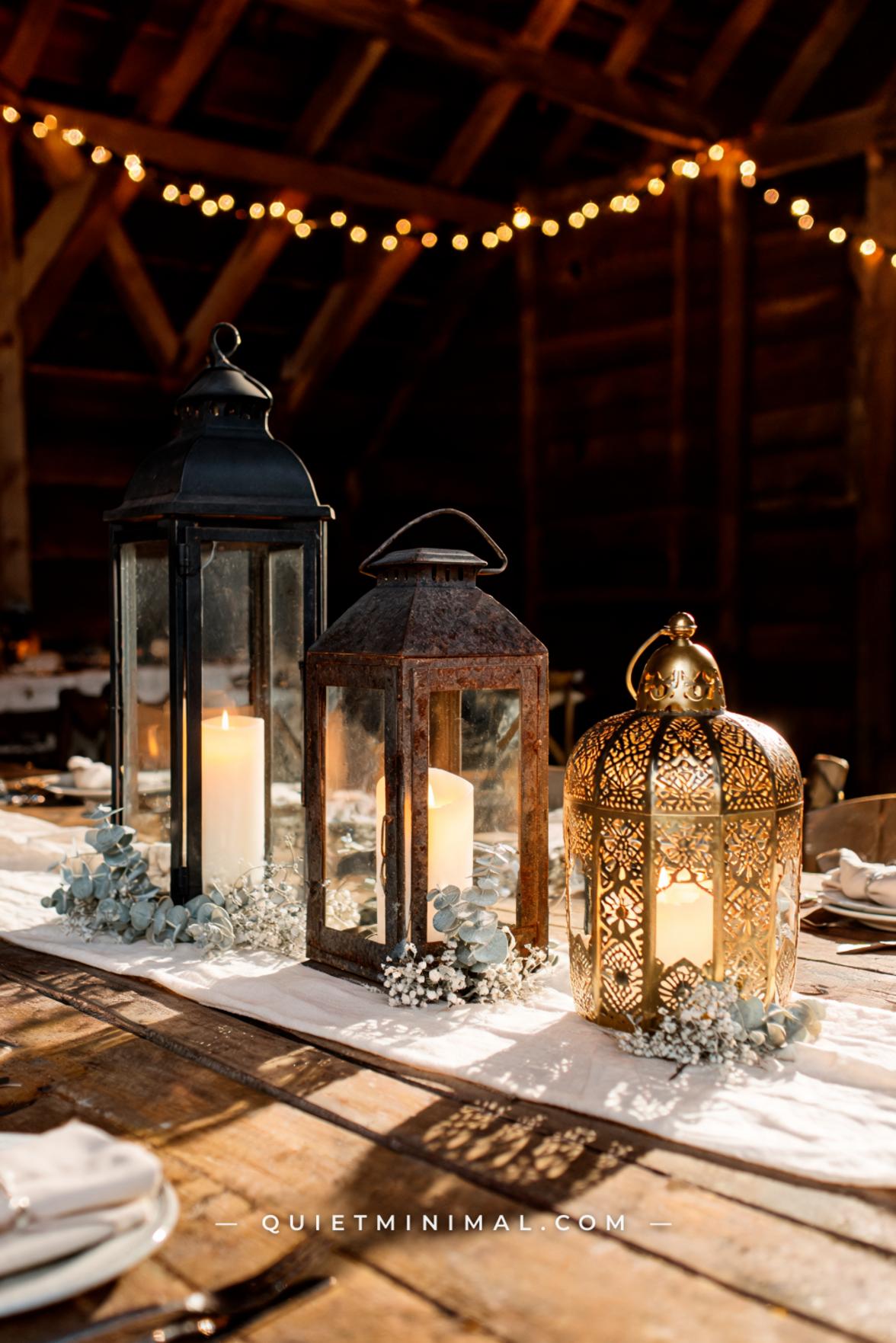 A wide vertical photograph captures three different iron lantern silhouettes arranged side by side on a long reclaimed w