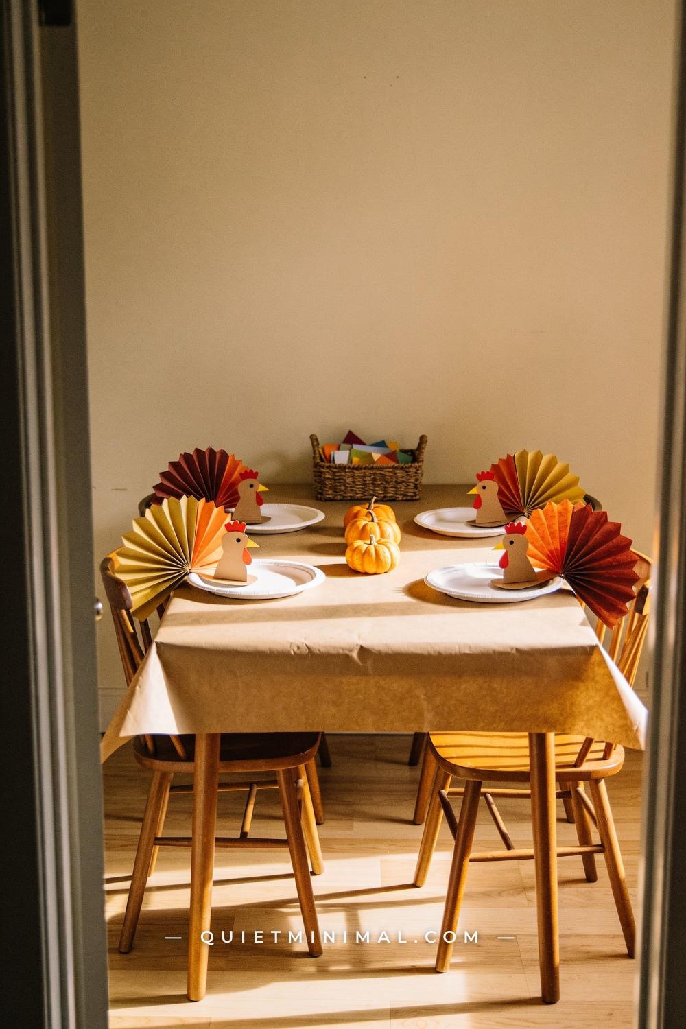 A wide establishing shot of the entire kids table from the doorway showing four place settings