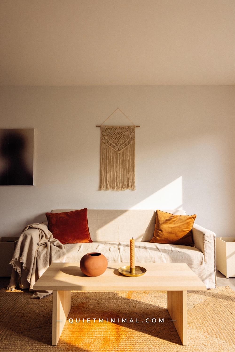 A wide establishing shot from across a living room taken from a straight-on wall view
