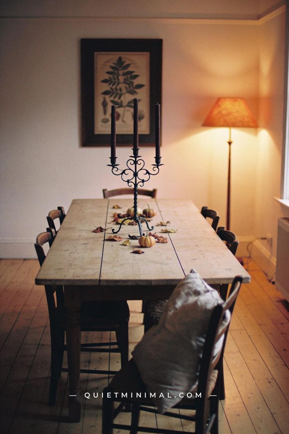 A wide establishing shot taken from across the room showing a dining room from the far corner