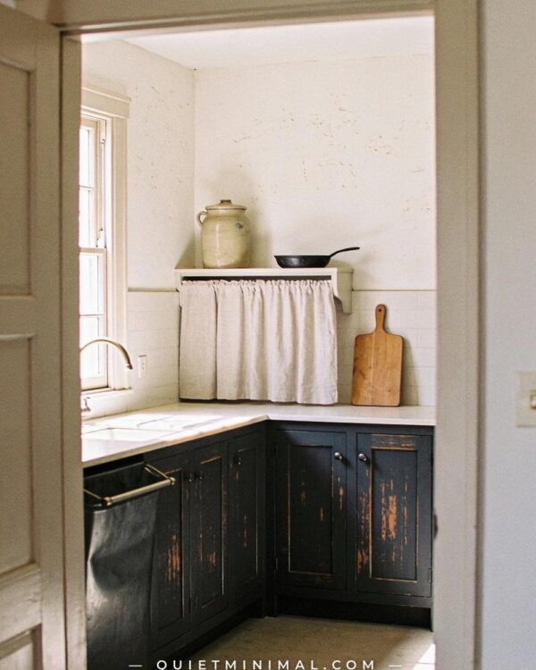 13 Wabi-Sabi Kitchen Cabinet Ideas With Dark Distressed Paint, Iron Pulls, and Imperfect Grain