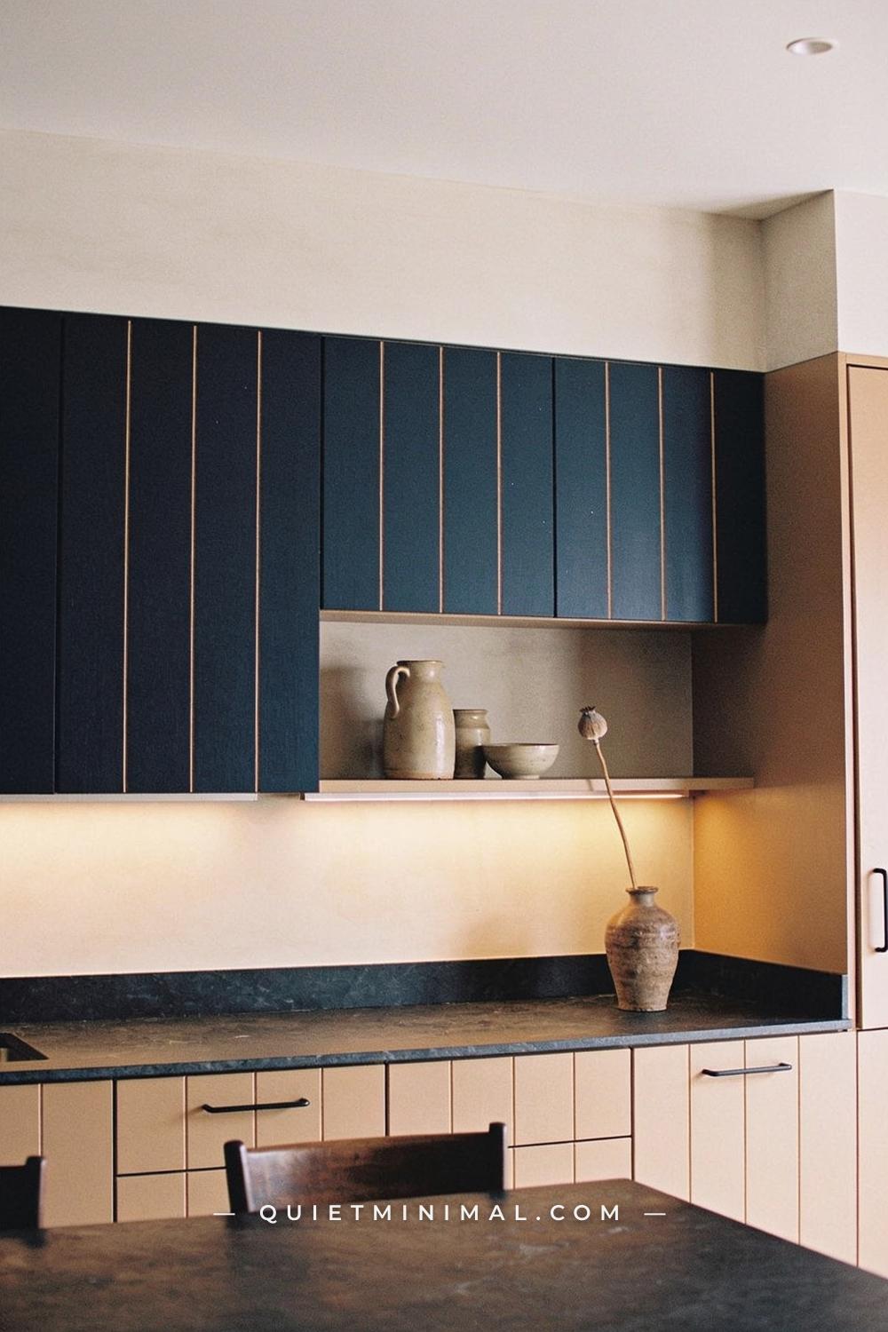 A wide establishing shot of a kitchen from a seated eye-level position near the kitchen island