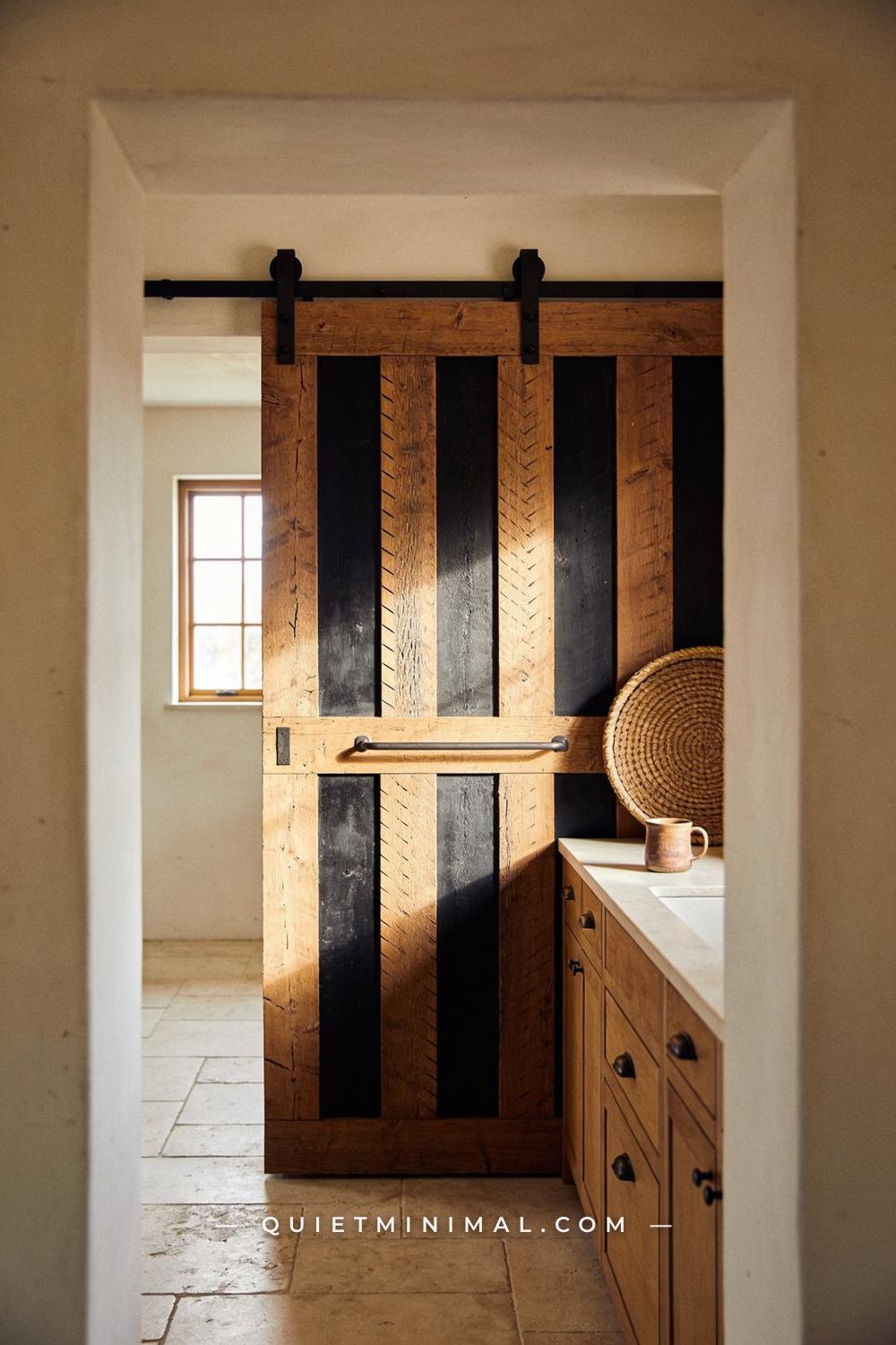 A medium-wide doorway-framed view of a kitchen pantry cabinet with rough-sawn oak door panels
